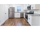 Well-equipped kitchen boasts stainless steel appliances, white cabinets, and granite countertops at 3215 Pennignton Cir, Atlanta, GA 30354