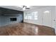 Bright living room showcasing hardwood floors, a painted brick fireplace, and natural light from large windows at 3215 Pennignton Cir, Atlanta, GA 30354