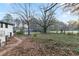 View of the yard featuring a grassy expanse covered in leaves and bordering a street at 3215 Pennignton Cir, Atlanta, GA 30354