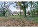 Large grassy yard featuring mature trees, some of which are covered in vines at 3215 Pennignton Cir, Atlanta, GA 30354