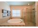 Well-lit bathroom showcasing a large soaking tub and glass-enclosed shower at 423 Hunt Ne St, Marietta, GA 30060
