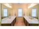 Bathroom featuring double sinks, large mirrors and tile flooring at 423 Hunt Ne St, Marietta, GA 30060