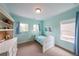 Charming bedroom with light blue walls and built-in shelving at 423 Hunt Ne St, Marietta, GA 30060