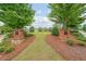 Welcome to this community, featuring a manicured lawn, tree-lined street, and brick signage at 423 Hunt Ne St, Marietta, GA 30060