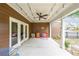 Inviting covered patio featuring string lights and a fan, perfect for outdoor relaxation and entertaining at 423 Hunt Ne St, Marietta, GA 30060