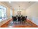 Formal dining room with hardwood floors, wainscoting, and ample seating for large gatherings at 423 Hunt Ne St, Marietta, GA 30060