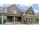 Back exterior view showcases the home's covered patio and garage at 423 Hunt Ne St, Marietta, GA 30060