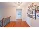Upstairs hallway with hardwood floors, gallery wall, and neutral color palette at 423 Hunt Ne St, Marietta, GA 30060