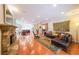 Open-concept design features hardwood floors, stone fireplace, and a seamless transition to the adjacent kitchen at 423 Hunt Ne St, Marietta, GA 30060