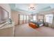 Spacious main bedroom featuring a four-poster bed, tray ceiling, and large windows at 423 Hunt Ne St, Marietta, GA 30060