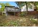 This backyard features a two-story deck with steps and supports, offering a serene view with lush trees at 509 Roy Sw St, Atlanta, GA 30310