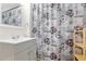 Bathroom showcasing a stylish shower curtain, vanity, and decorative mirror at 509 Roy Sw St, Atlanta, GA 30310