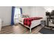 Bright bedroom with a large window, wood-look flooring, and a comfortable bed at 509 Roy Sw St, Atlanta, GA 30310