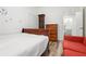 Bright bedroom with vintage clock, classic dresser and a red sofa at 509 Roy Sw St, Atlanta, GA 30310