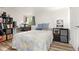 Bedroom featuring a comfortable bed, built-in shelving, and natural light from the window at 509 Roy Sw St, Atlanta, GA 30310