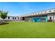 Commercial building featuring a green lawn, modern outdoor seating, unique modular structures, and a clear blue sky at 509 Roy Sw St, Atlanta, GA 30310