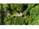 Aerial view of property surrounded by mature trees offering privacy and seclusion at 1665 Chevron Way, Sandy Springs, GA 30350