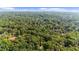 The home is surrounded by lush greenery, showcasing a private wooded lot at 1665 Chevron Way, Sandy Springs, GA 30350