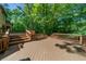 Multi-level deck features wood railings and stairs offering a backyard entertaining space at 1665 Chevron Way, Sandy Springs, GA 30350