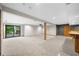 Finished basement with bar area, tiled floor, and access to the backyard at 1665 Chevron Way, Sandy Springs, GA 30350