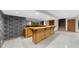 Basement with a wooden bar, staircase, and unique wallpaper accent wall at 1665 Chevron Way, Sandy Springs, GA 30350