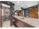 Bathroom featuring a large mirror, dual sinks, and wallpaper design at 1665 Chevron Way, Sandy Springs, GA 30350