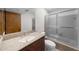 Bathroom features a granite countertop, dark wood cabinet, and shower with sliding glass doors at 1665 Chevron Way, Sandy Springs, GA 30350