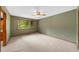 Spacious bedroom with large window overlooking lush greenery and a ceiling fan at 1665 Chevron Way, Sandy Springs, GA 30350