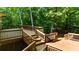 Multi-level wooden deck surrounded by lush trees creates a secluded outdoor space at 1665 Chevron Way, Sandy Springs, GA 30350
