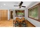 Cozy dining area adjacent to the kitchen with wood floors, a ceiling fan, and natural lighting at 1665 Chevron Way, Sandy Springs, GA 30350