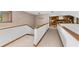 Upstairs hallway with carpeted floors leading to a cozy sitting room with a fireplace at 1665 Chevron Way, Sandy Springs, GA 30350