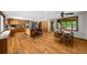 Open-concept kitchen and dining area with wooden floors, island, and modern appliances at 1665 Chevron Way, Sandy Springs, GA 30350