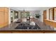 Close up of a kitchen island with granite countertop, copper faucet, and a flat top electric range at 1665 Chevron Way, Sandy Springs, GA 30350