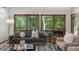 Cozy living room with large windows offering serene views, furnished with a comfortable sofa and stylish accents at 1665 Chevron Way, Sandy Springs, GA 30350