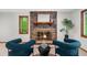 Living room showcasing a brick fireplace and two blue chairs at 1665 Chevron Way, Sandy Springs, GA 30350