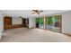 Open living room features built-in shelving and sliding glass doors leading to the pool area at 1665 Chevron Way, Sandy Springs, GA 30350