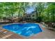 Backyard with a spacious pool deck and a large in-ground pool, perfect for outdoor relaxation and entertaining at 1665 Chevron Way, Sandy Springs, GA 30350