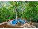 Aerial view of the pool surrounded by the deck and lush trees offers an inviting outdoor retreat at 1665 Chevron Way, Sandy Springs, GA 30350