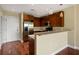 Kitchen with dark wood cabinets, stainless steel appliances, and an island with countertop seating at 201 W Ponce De Leon Ave # 515, Decatur, GA 30030