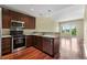Cozy kitchen with stainless steel appliances, dark wood cabinetry, and an open-concept design at 201 W Ponce De Leon Ave # 515, Decatur, GA 30030