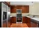 The U-shaped kitchen features stainless appliances, dark cabinetry, and light countertops at 201 W Ponce De Leon Ave # 515, Decatur, GA 30030