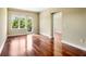 Open living area featuring hardwood floors, bright window with balcony, and neutral wall paint at 201 W Ponce De Leon Ave # 515, Decatur, GA 30030