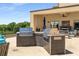 The outdoor kitchen boasts stainless steel grills, granite countertops, and seating under a covered patio at 201 W Ponce De Leon Ave # 515, Decatur, GA 30030