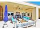 Covered outdoor patio with modern seating, fireplace, ceiling fan, and beautiful stone flooring at 201 W Ponce De Leon Ave # 515, Decatur, GA 30030