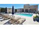 Inviting community swimming pool with lounge chairs, umbrellas, and lush landscaping at 201 W Ponce De Leon Ave # 515, Decatur, GA 30030
