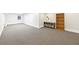 Spacious carpeted basement with white trim and access to a door and a shelving unit at 3501 Emperor Way, Tucker, GA 30084