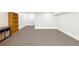 Finished basement area featuring neutral carpeting, a bookshelf, and painted trim at 3501 Emperor Way, Tucker, GA 30084
