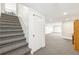 View of the finished basement with neutral carpet, white walls, and access to the main level at 3501 Emperor Way, Tucker, GA 30084