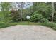 Backyard features a paved half basketball court surrounded by lush landscaping at 3501 Emperor Way, Tucker, GA 30084