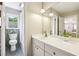 Bright bathroom with a white vanity, a single sink, and a view of the window to outside at 3501 Emperor Way, Tucker, GA 30084